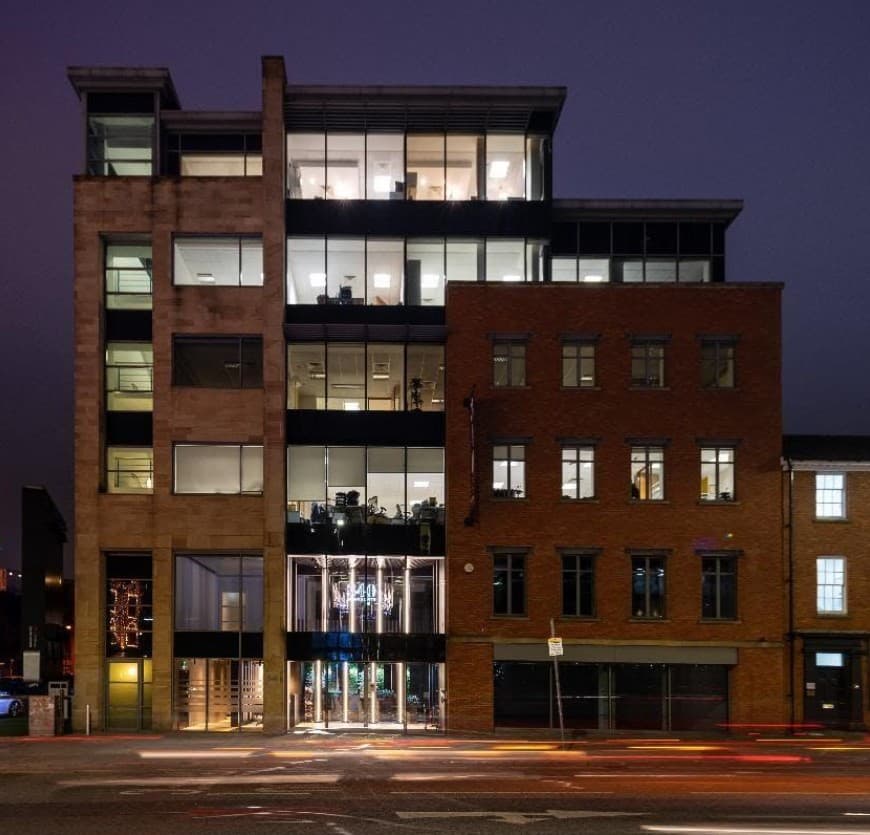 Commercial development at night demonstrating investment protection and cost management services